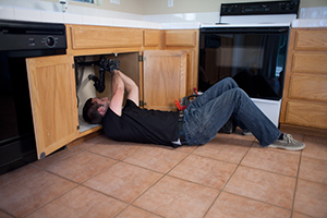 garbage disposal repair Todd, one of our Foster City garbage disposal repair pros is under the sink fixing a unit