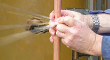 leaky pipe one of our Foster City plumbers is fixing a leaky pipe